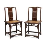 A pair of Chinese hongmu chairs 18th / early 19th century The shaped top rails above serpentine...
