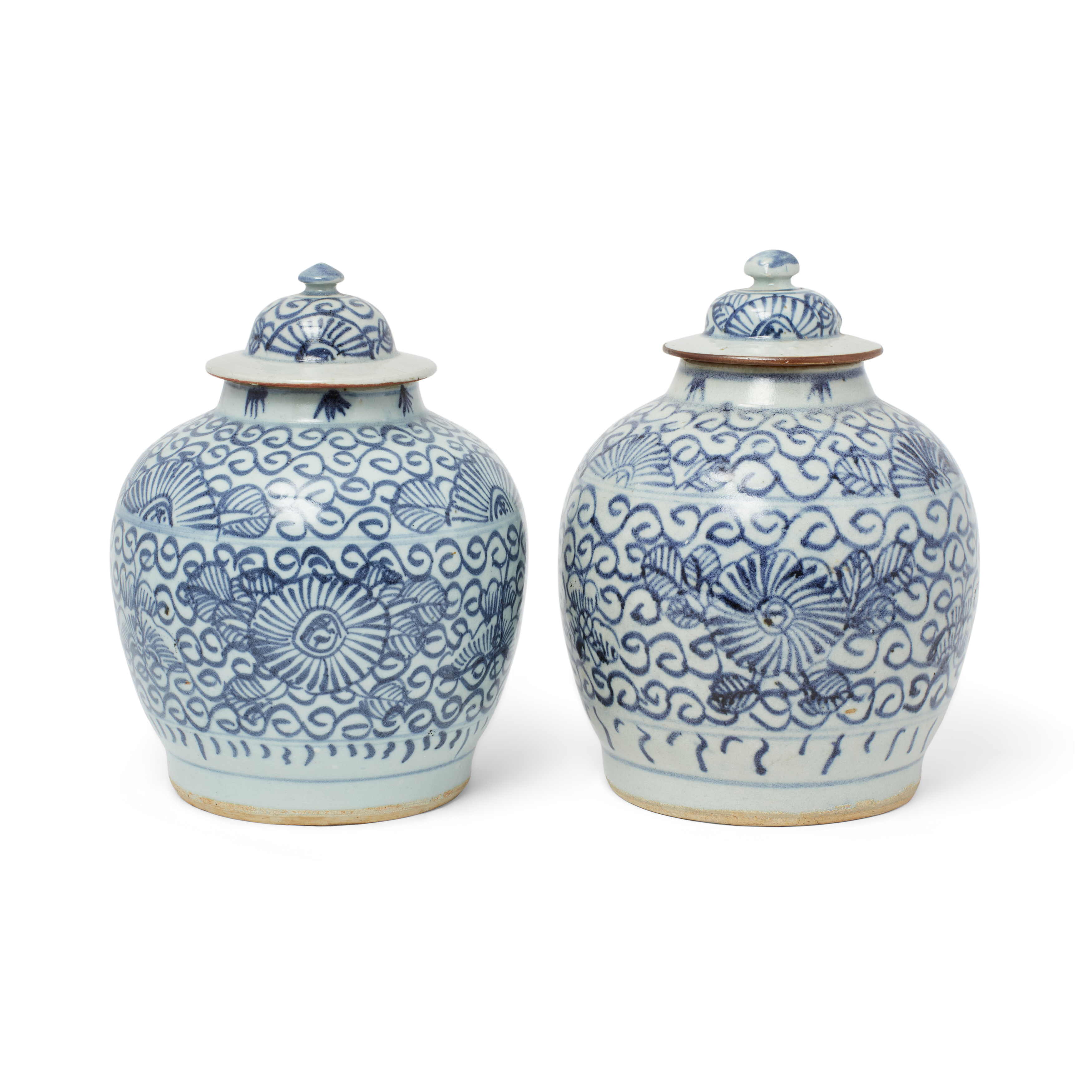 A pair of Chinese blue and white 'peonies' jars and covers Qing dynasty, 19th century Each rais...