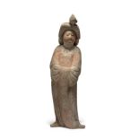 A Chinese painted pottery figure of a court lady Tang dynasty Standing slightly swaying with he...