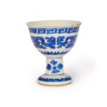 A small Chinese blue and white soft paste stem cup Qing dynasty, 19th century Painted with arch...