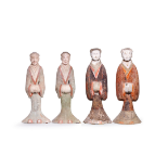 Four large Chinese pottery figures of attendants Han dynasty Each modelled standing wearing pai...