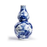 A Chinese blue and white double gourd vase Late Qing dynasty Decorated with four panels of 'pre...