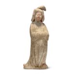 A Chinese pottery figure of a court lady Tang dynasty Modelled swaying to the left with hands h...