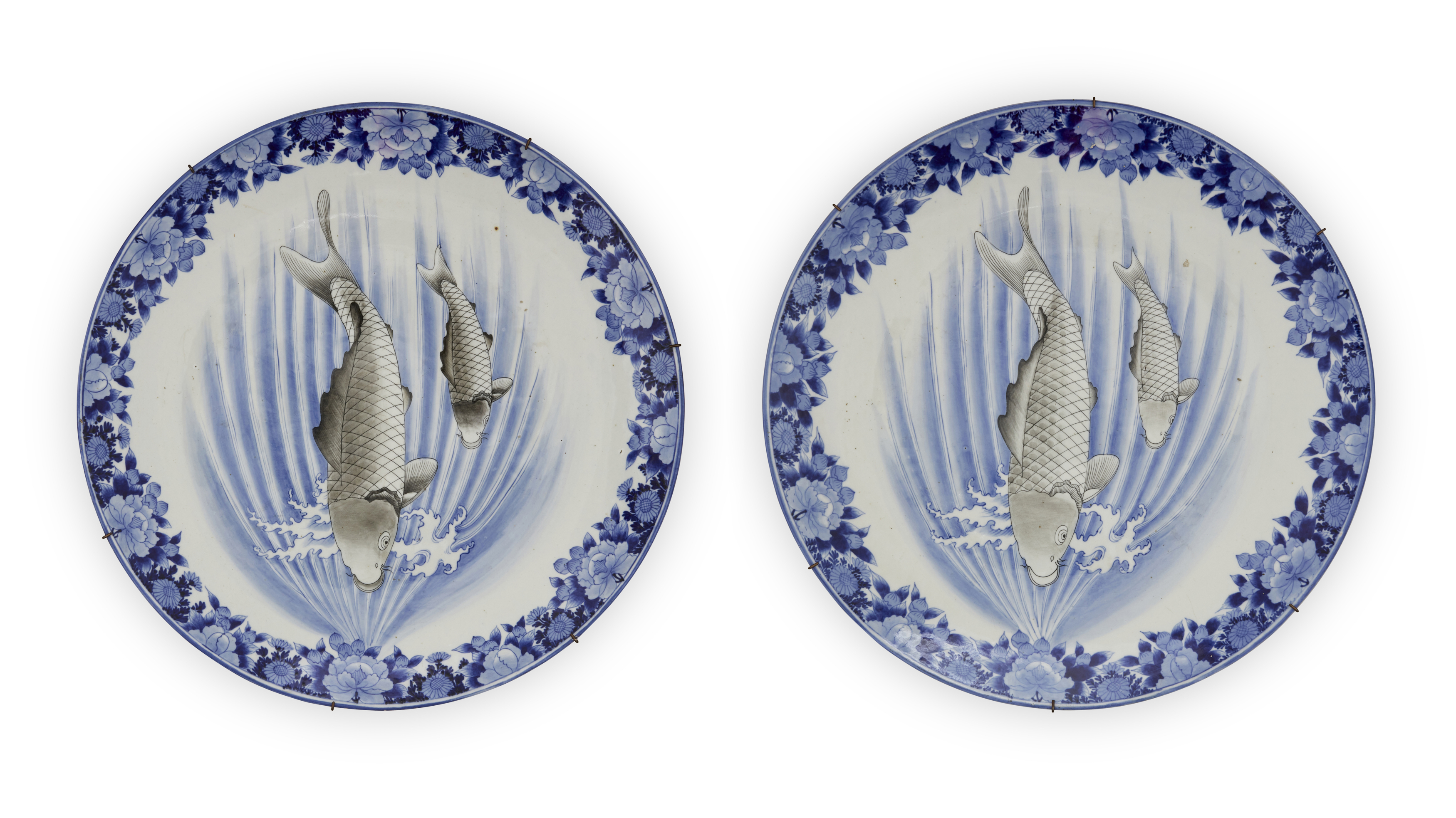 A pair of large Japanese Arita porcelain chargers, Meiji period, 19th century, Each painted with ...