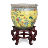 A large Chinese yellow-ground famille verte fish bowl, Qing dynasty, mid-19th century, Enamelled ...