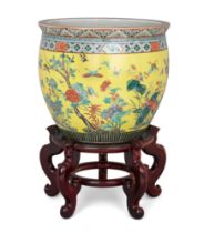 A large Chinese yellow-ground famille verte fish bowl, Qing dynasty, mid-19th century, Enamelled ...