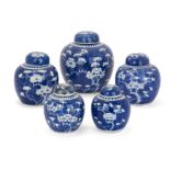 Five Chinese blue and white 'prunus' jars and covers, Late 19th - early 20th century, Each decora...