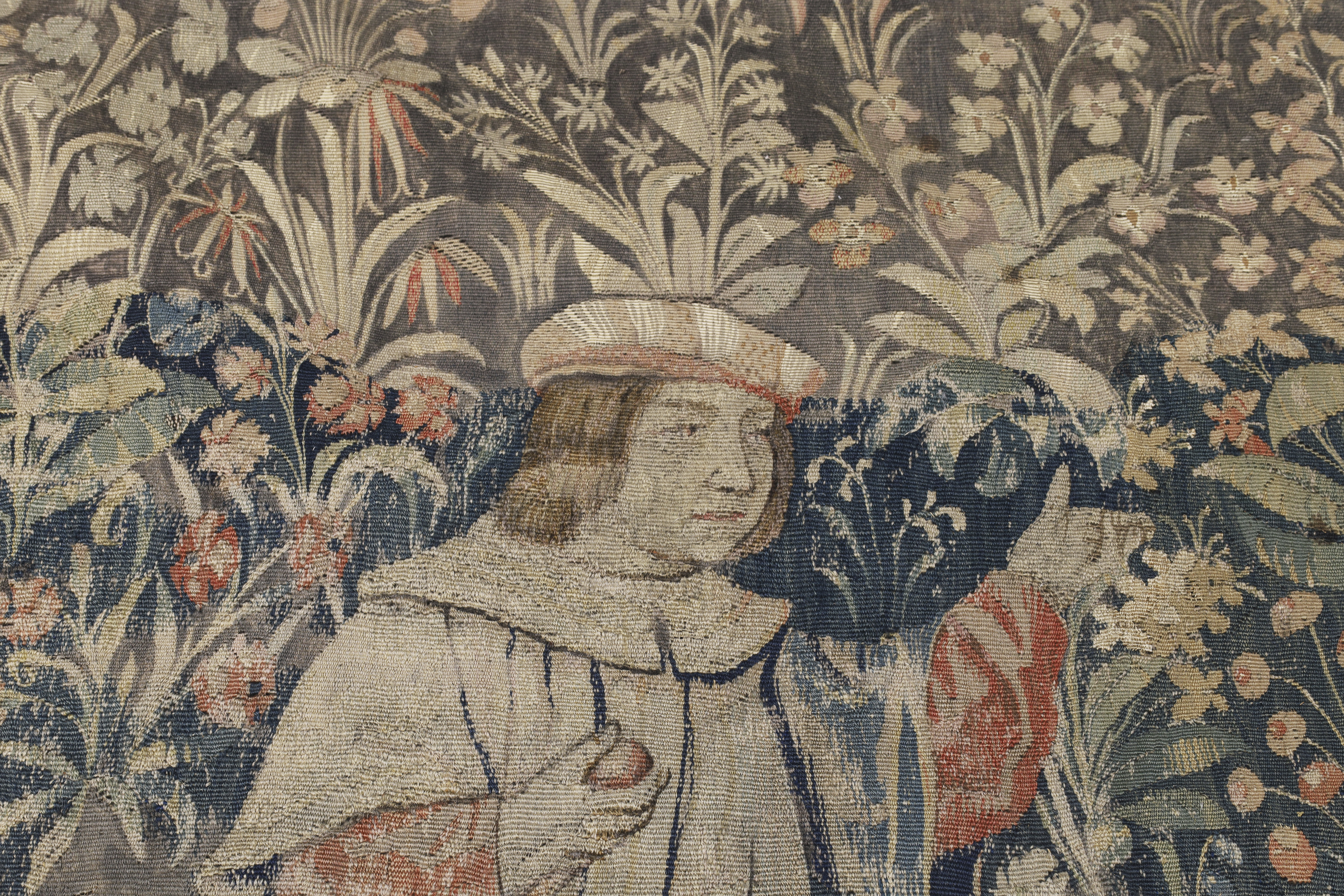 A Franco-Flemish millefleurs tapestry, Early 16th century, A noblewoman stands to centre reading ... - Image 3 of 5