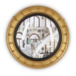 A giltwood convex mirror, Of Regency style, second half 20th century,  The moulded frame with bal...