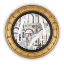 A giltwood convex mirror, Of Regency style, second half 20th century,  The moulded frame with bal...