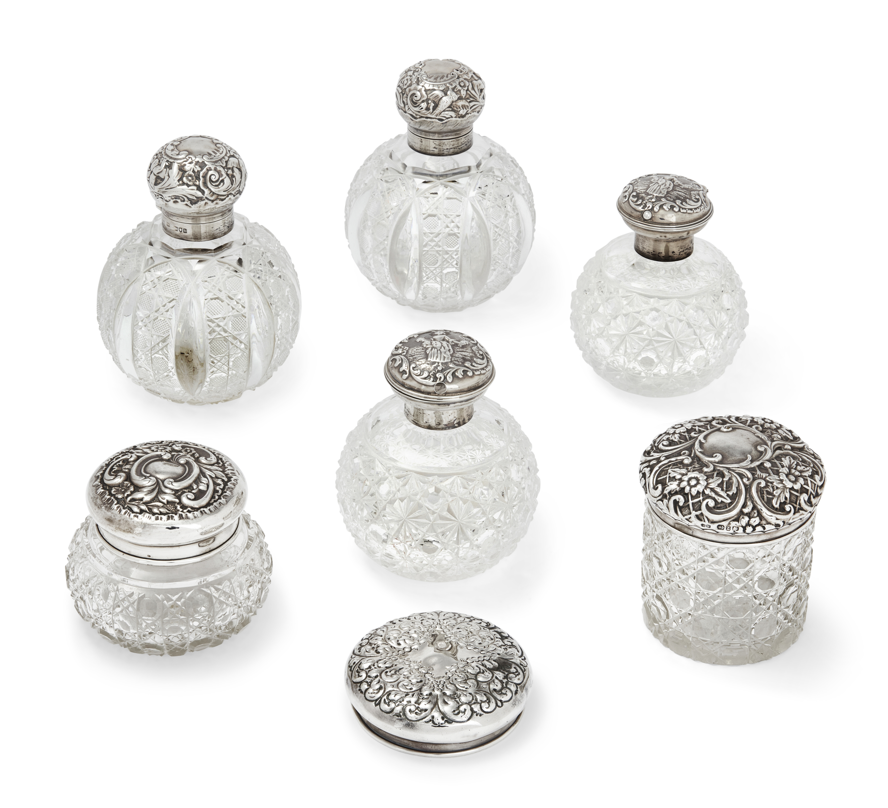 Four late Victorian silver mounted scent bottles,  Various dates and makers, The group comprising...