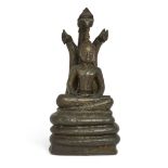 A Burmese bronze figure of Buddha Nagaraja, 19th century, Seated in dhyanasana beneath a three-he...
