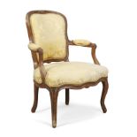 A French walnut fauteuil, Of Louis XV style, last quarter 19th century, With yellow silk damask u...