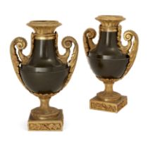 A pair of French ormolu and patinated bronze urns, Early 19th century,  Each with twin beaded and...