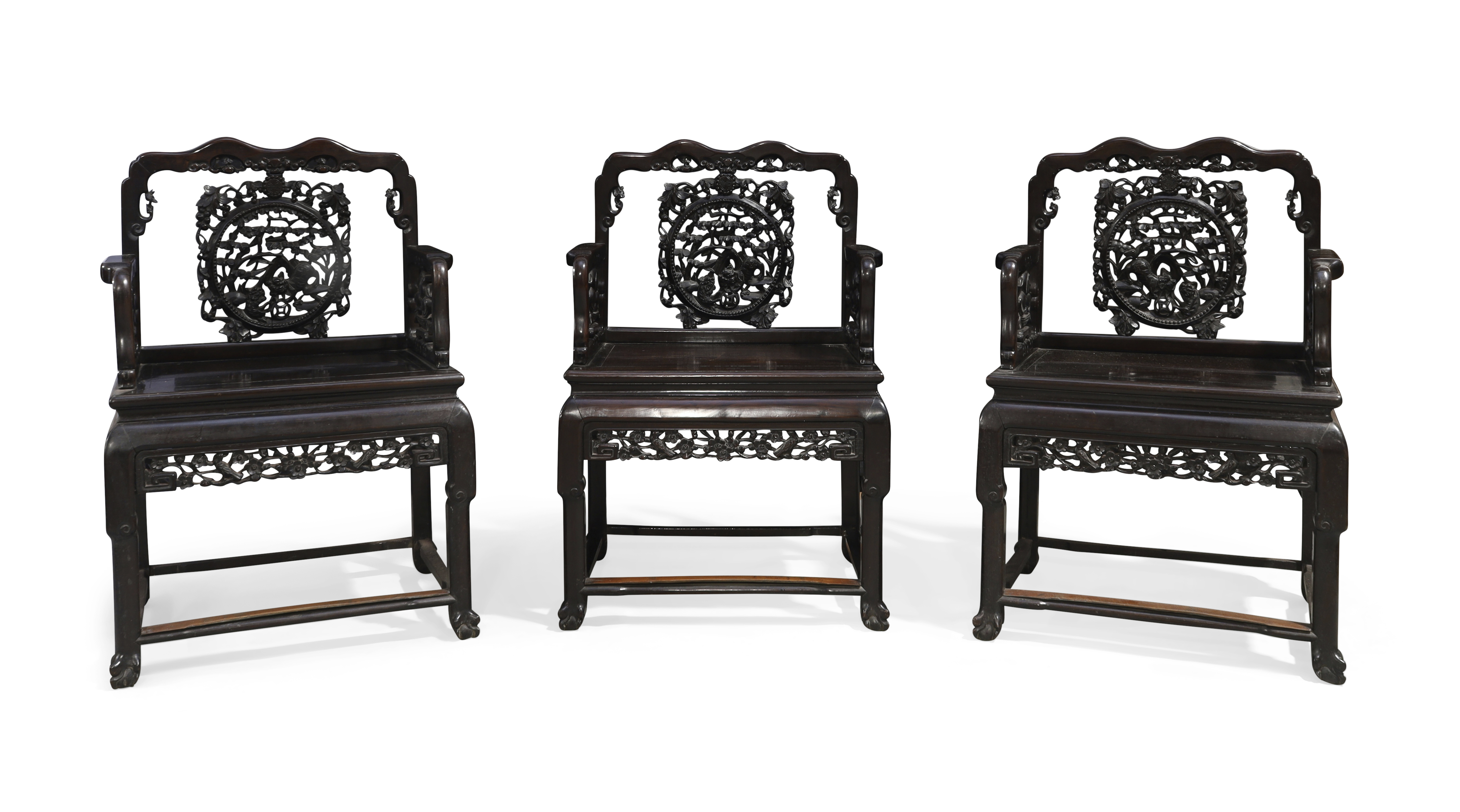 A set of three Chinese hongmu armchairs, Qing dynasty, 19th century, Each with carved back panel ...