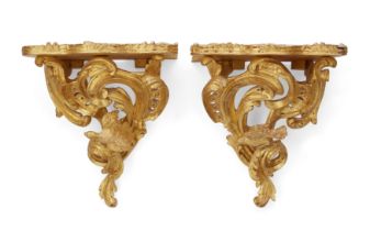 A pair of giltwood wall brackets, Of Louis XV style, second half 20th century, Each with a projec...