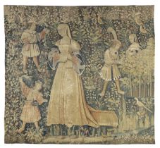 A Franco-Flemish millefleurs tapestry, Early 16th century, A noblewoman stands to centre reading ...