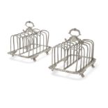 A pair of George V silver toast racks, London, 1914, Elkington & Co., Designed with seven bars to...