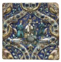 A square moulded polychrome pottery tile, Tehran, Qajar Iran, c.1880, A seated ruler flanked by a...