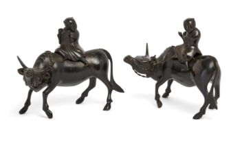 A pair of Chinese bonze censers boy and buffalo censers, 19th century, Each modelled with cover c...
