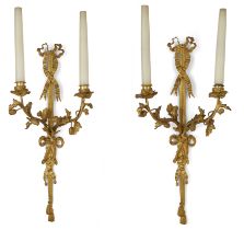 A pair of French gilt-bronze twin-light wall appliques, Of Louis XVI style, late 19th century,  E...