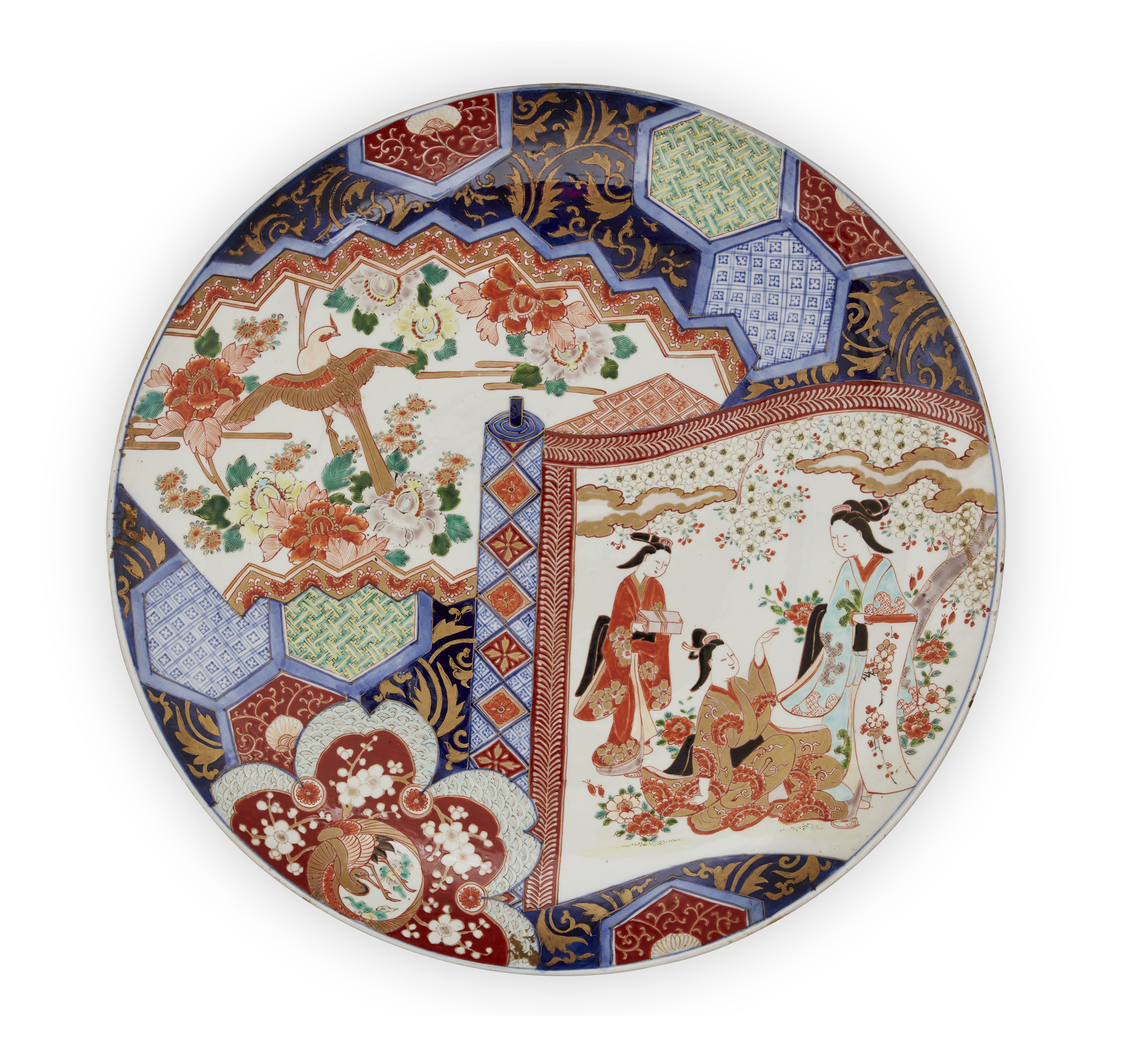 A large Japanese Imari charger, Meiji period, Painted with two panels, one depicting ladies benea...