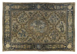 An English needlework table carpet, 17th century, Worked in wools and silks, centred with an oval...