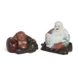 A Chinese famille rose figure of Budai and a Japanese painted plaster figure of Hotei, Republic p...