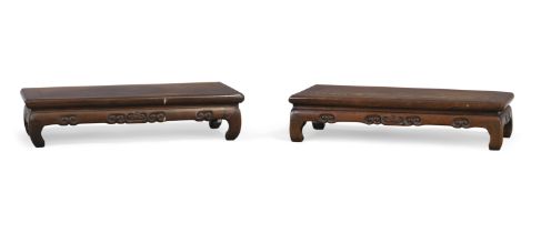 A pair of Chinese hongmu scholar’s stands, Qing dynasty, 19th century, Each formed as a kang tabl...