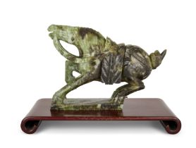 A Chinese green hardstone carving of a horse, 20th century, Carved with head raised, 35cm long, o...
