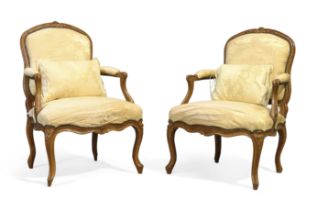 A pair of French beechwood fauteuils, Of Louis XV style, last quarter 19th century, With carved f...