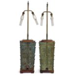 A pair of Chinese archaistic bronze lamps, Late 20th century, Cast as ritual bronze vases, fangyi...