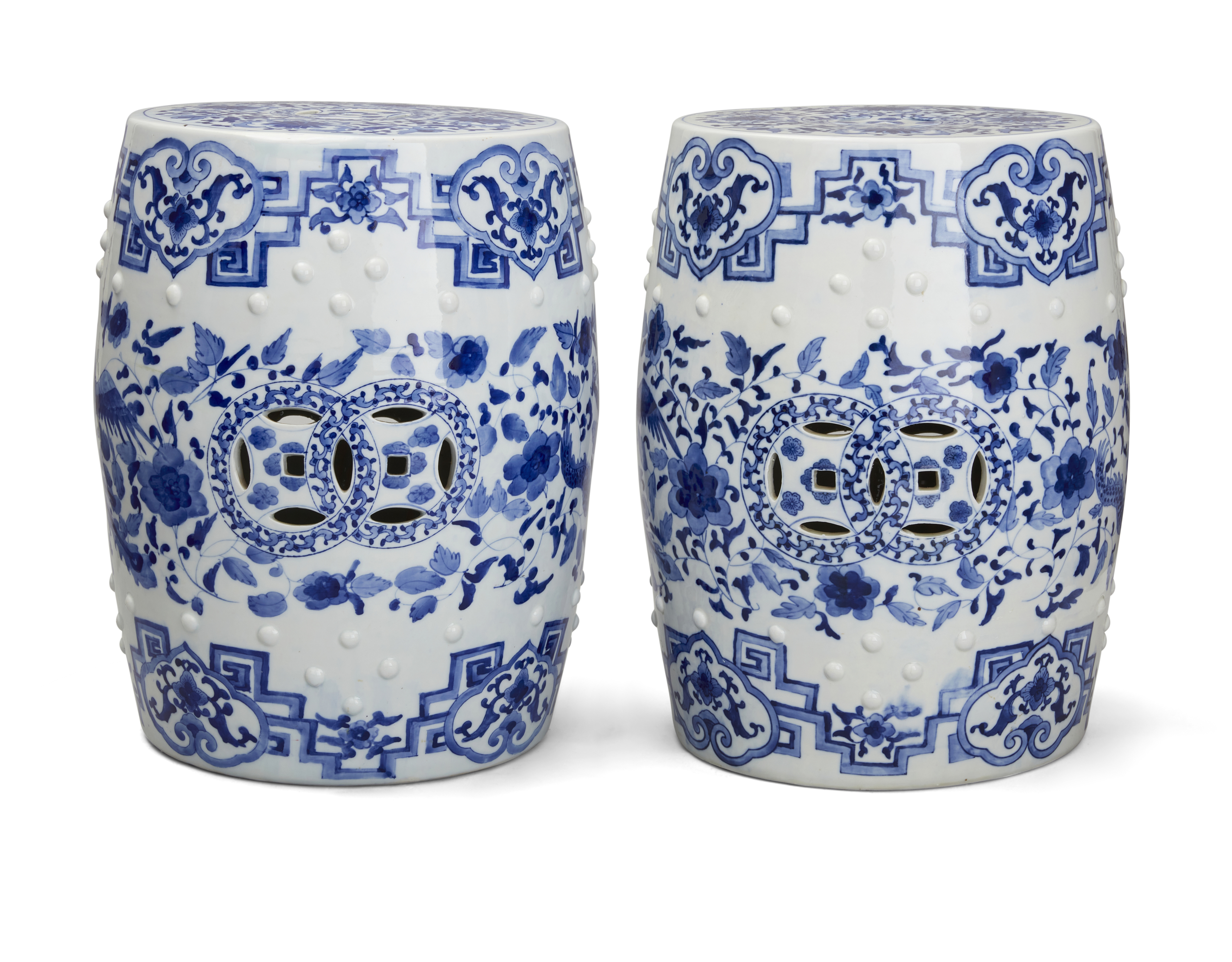 A pair of Chinese blue and white barrel-form stools, 20th century, Pierced with cash motifs to th...