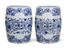 A pair of Chinese blue and white barrel-form stools, 20th century, Pierced with cash motifs to th...