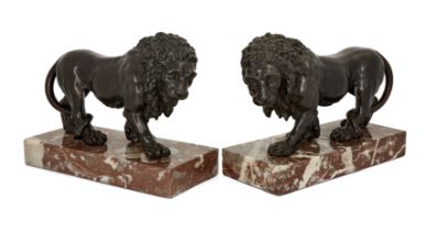 A pair of French bronze models of pacing lions, Second half 19th century, Each shown pacing with ...