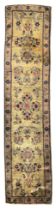 A Persian silk Kashan narrow runner, First quarter 20th century,  The central field with floral d...