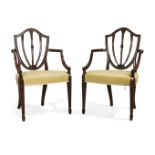 A pair of Victorian mahogany open armchairs, By Wright & Mansfield, of Hepplewhite design, third ...