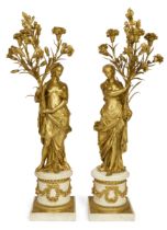 A pair of French ormolu figural three-light candelabra, After a model by François Rémond, of Loui...