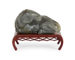 A Chinese Ming style grey jade figure of a recumbent horse, Republic period, Carved with head tur...