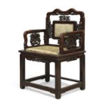 A Chinese hongmu armchair, Qing dynasty, 19th century, With carved and pierced panels to back and...