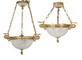 A pair of French gilt-bronze and cut-glass hanging ceiling lights, Of Empire style, second half 2...