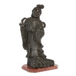 A large Chinese bronze figure of an immortal, Late 19th century, Depicted standing holding a peac...