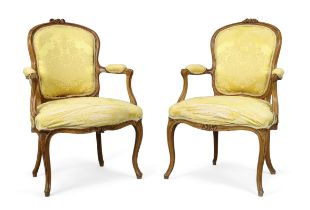 A near pair of French walnut fauteuils, Of Louis XV style, last quarter 19th century, With yellow...