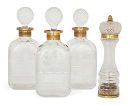 Three gilt-brass mounted glass decanters and a pepper mill, Second half 20th century,  The matchi...