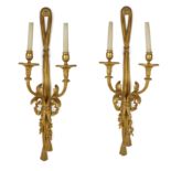 A pair of French gilt-bronze twin-light wall appliques, Of Louis XVI style, first half 20th centu...