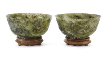 A pair of large Chinese spinach hardstone bowls, 20th century, Each carved in relief to the exter...