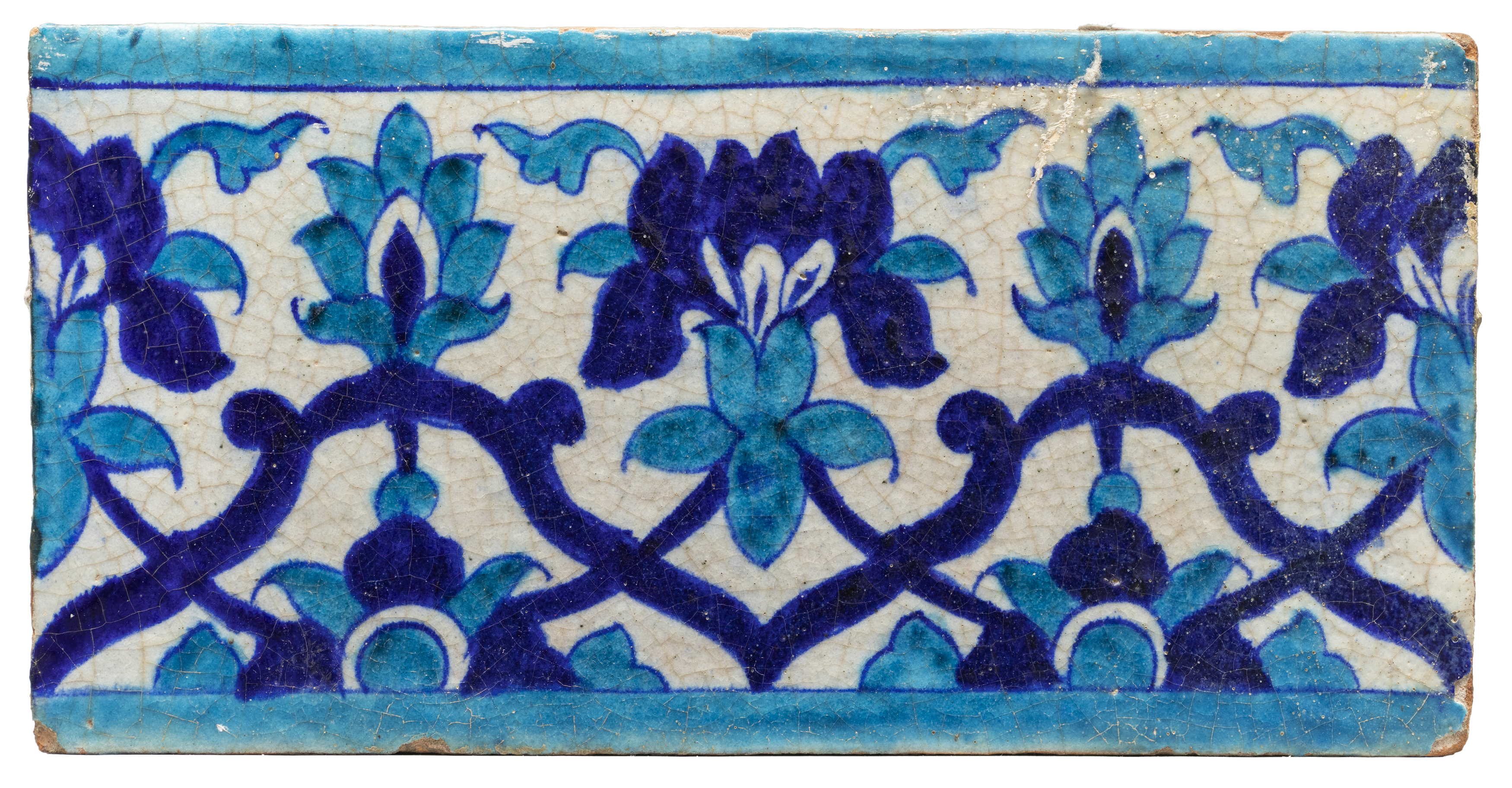 A turquoise and cobalt blue border tile, Multan, North India, 19th century, A swaying floral tend...