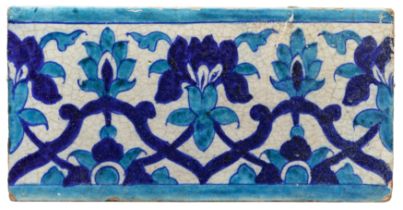 A turquoise and cobalt blue border tile, Multan, North India, 19th century, A swaying floral tend...