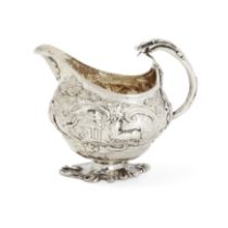 A silver milk jug decorated with pastoral scenes, Marked only with lion passant and maker's mark ...