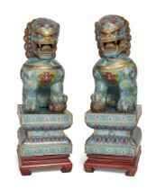 A pair of large Chinese cloisonné and gilt metal Buddhist lions,  20th century, Each modelled sea...